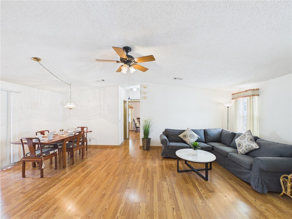 1203 Calusa Drive Sebastian, FL 32976 - Photo 3 of 27 a living room with furniture and a wooden floor