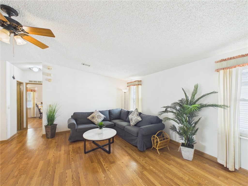 1203 Calusa Drive Sebastian, FL 32976 - Photo 4 of 27 a living room with furniture potted plant and a wooden floor