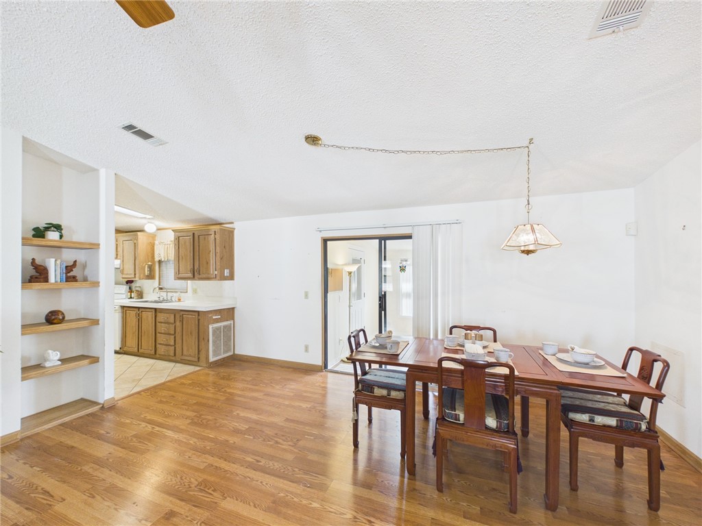 1203 Calusa Drive Sebastian, FL 32976 - Photo 8 of 27 a view of a dining room with furniture and wooden floor