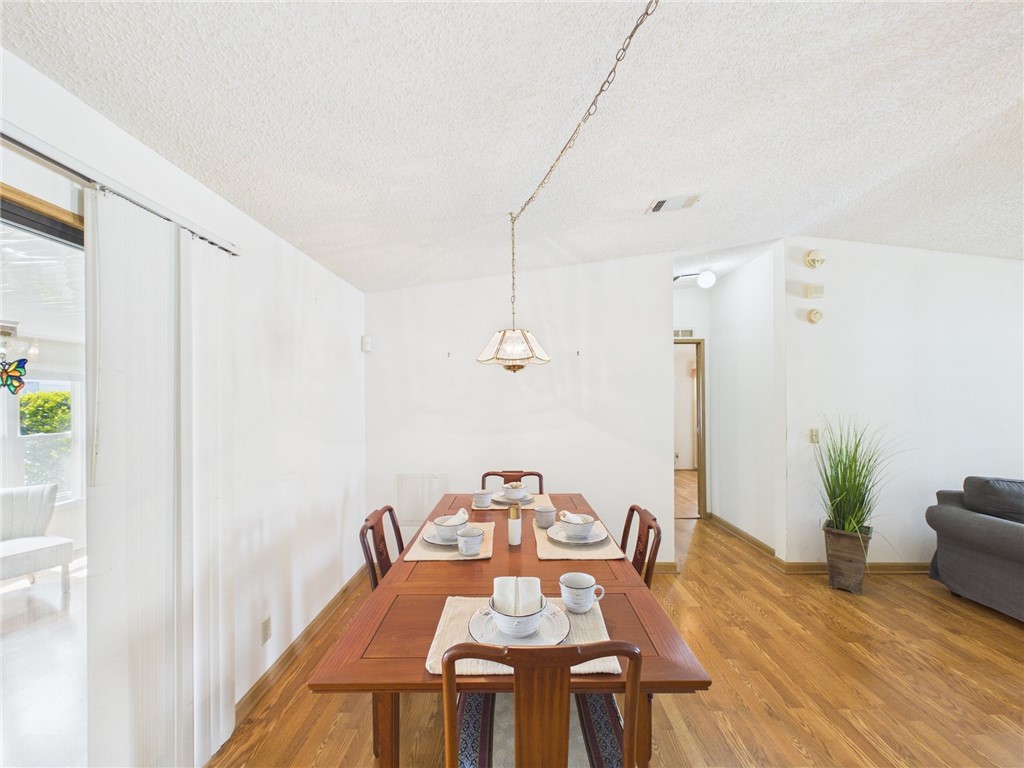 1203 Calusa Drive Sebastian, FL 32976 - Photo 9 of 27 a dining room with furniture and wooden floor