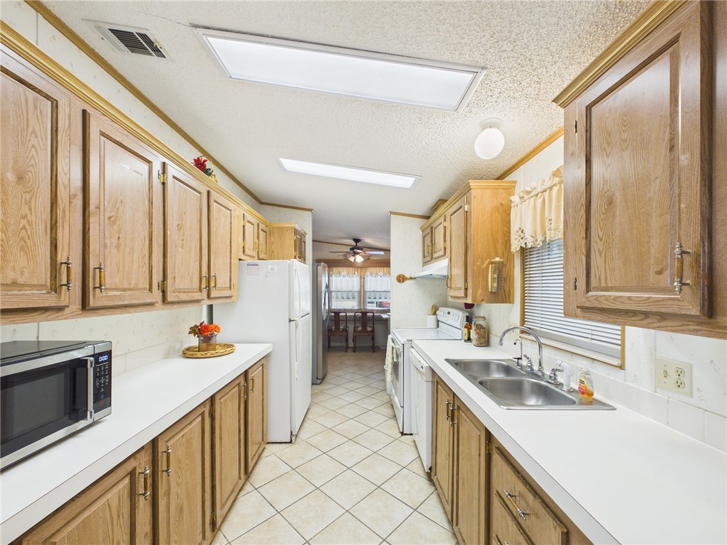 1203 Calusa Drive Sebastian, FL 32976 - Photo 10 of 27 a kitchen with stainless steel appliances sink cabinets and window