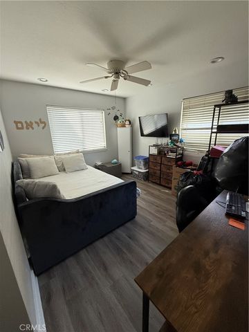 a bedroom with bed couch and window