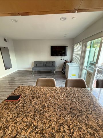 a kitchen with a table chairs and wooden floor
