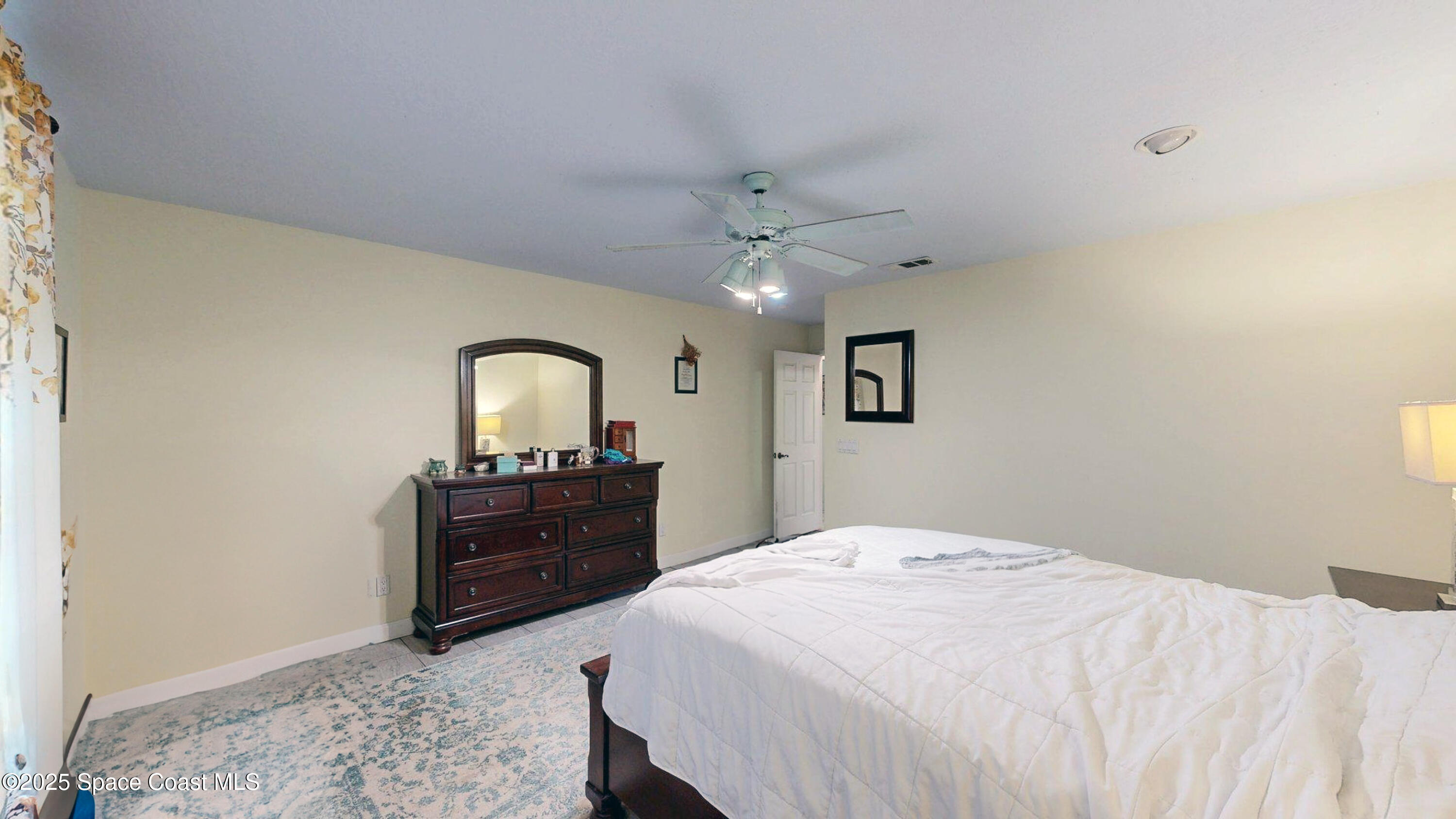 2832 School Drive Palm Bay, FL 32905 - Photo 31 of 55 a bedroom with a bed and a dresser