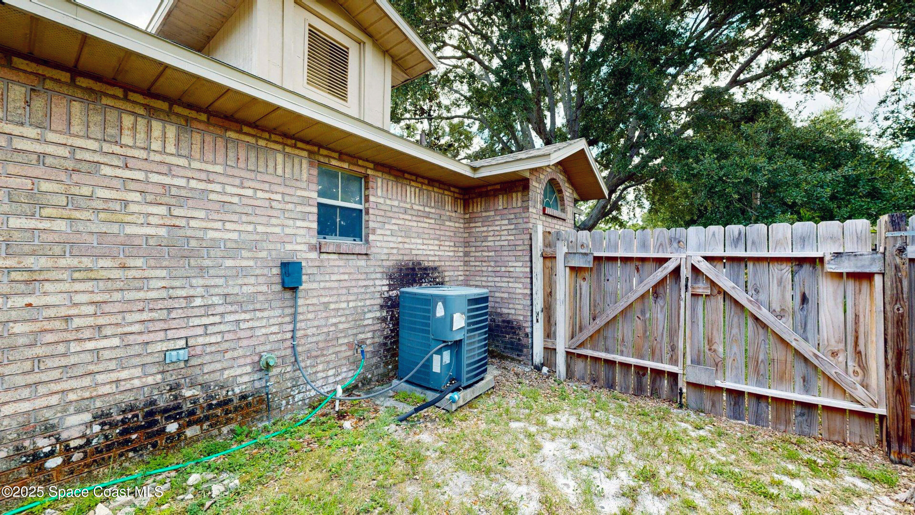 2832 School Drive Palm Bay, FL 32905 - Photo 43 of 55 a view of a house with a yard and wooden fence