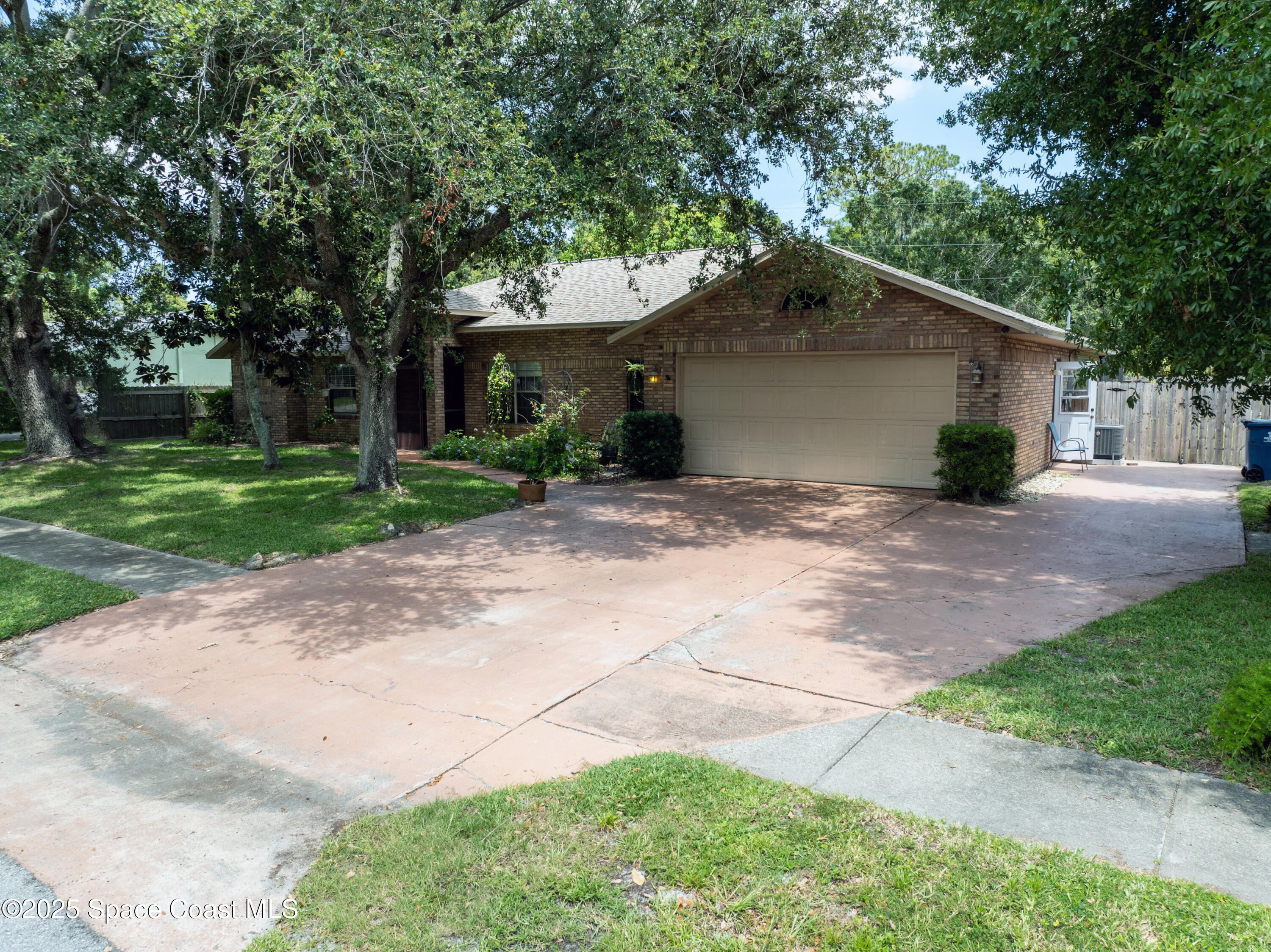 2832 School Drive Palm Bay, FL 32905 - Photo 52 of 55 a view of a house with a yard and large tree