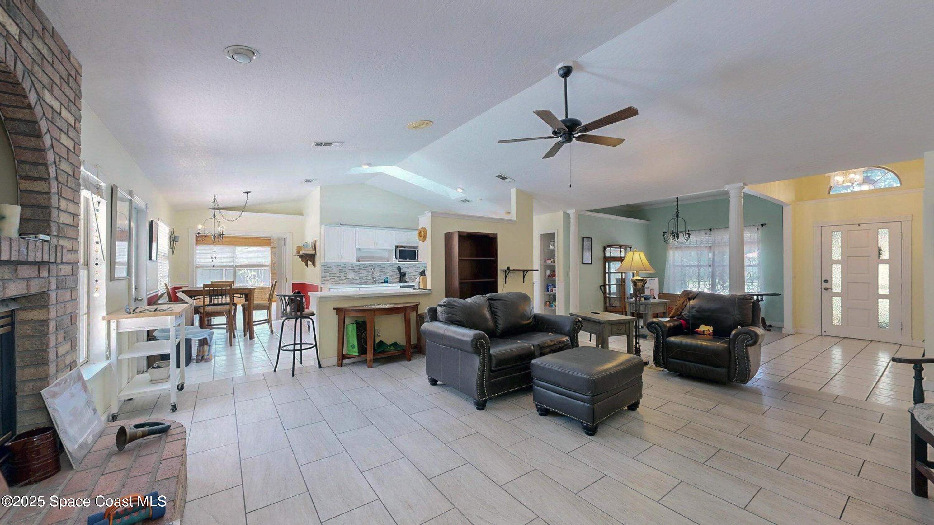 2832 School Drive Palm Bay, FL 32905 - Photo 7 of 55 a living room with furniture and a fireplace