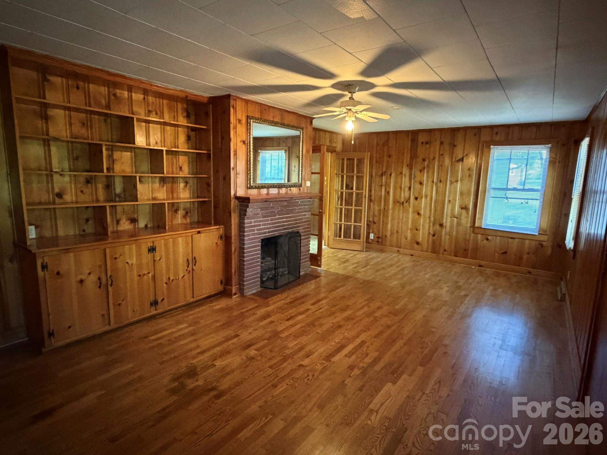 382 Alexis High Shoals Road Dallas, NC 28034 - Photo 11 of 43 a view of empty room with wooden floor and fireplace