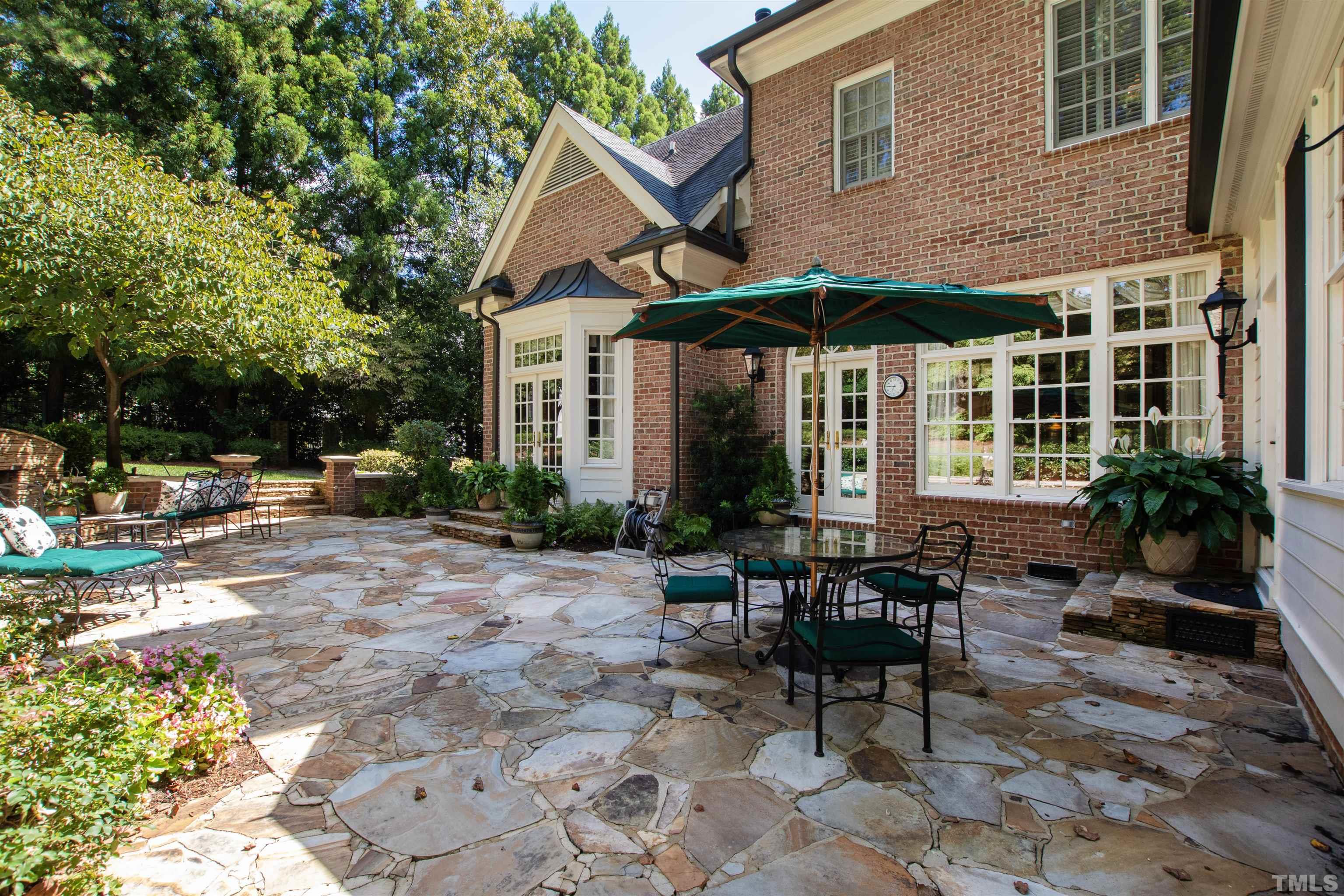 1909 Chase Court Raleigh, NC 27607 - Photo 3 of 87 a view of a patio with table and chairs under an umbrella