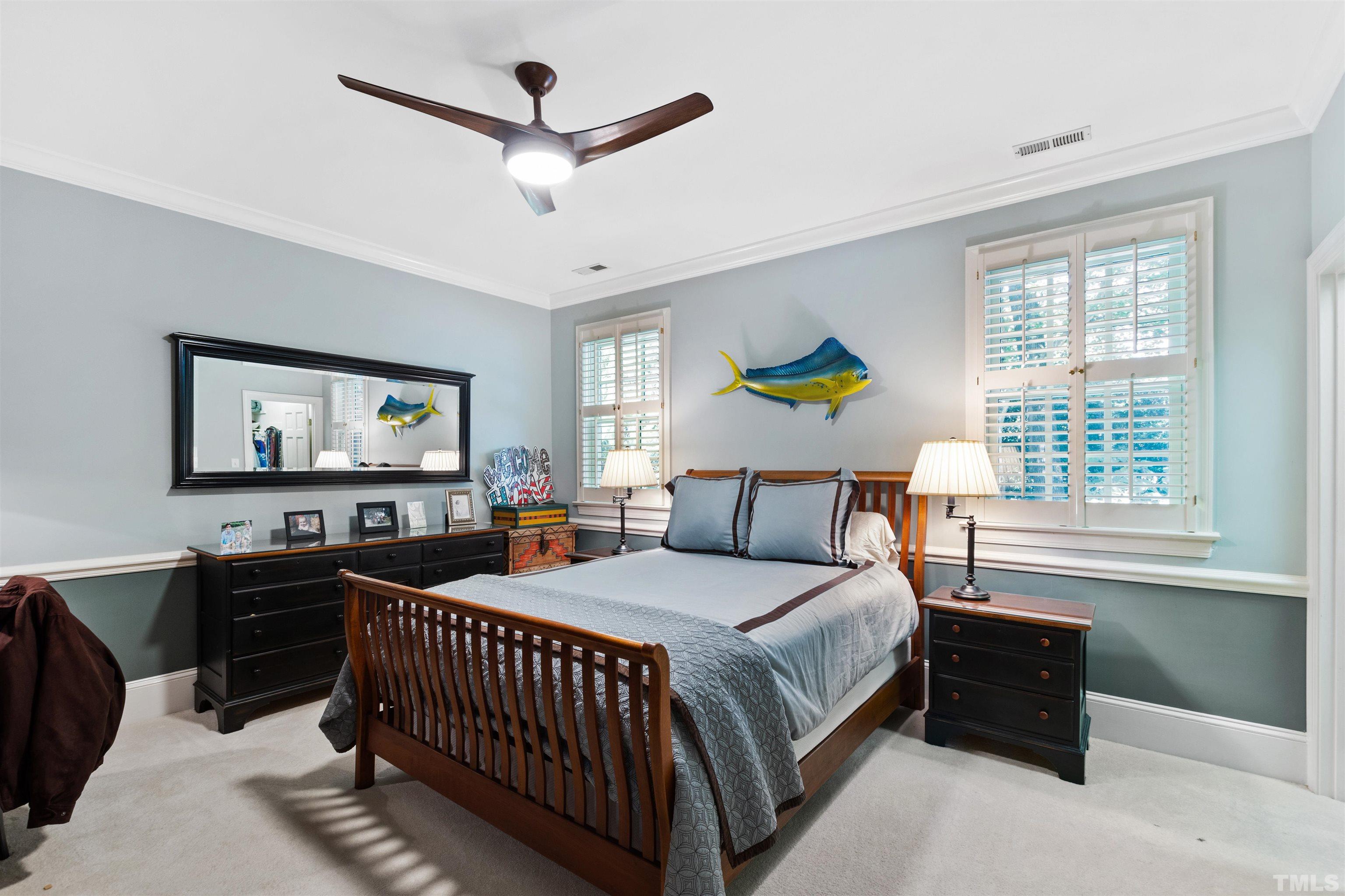 1909 Chase Court Raleigh, NC 27607 - Photo 58 of 87 a bedroom with a bed a chandelier and a window