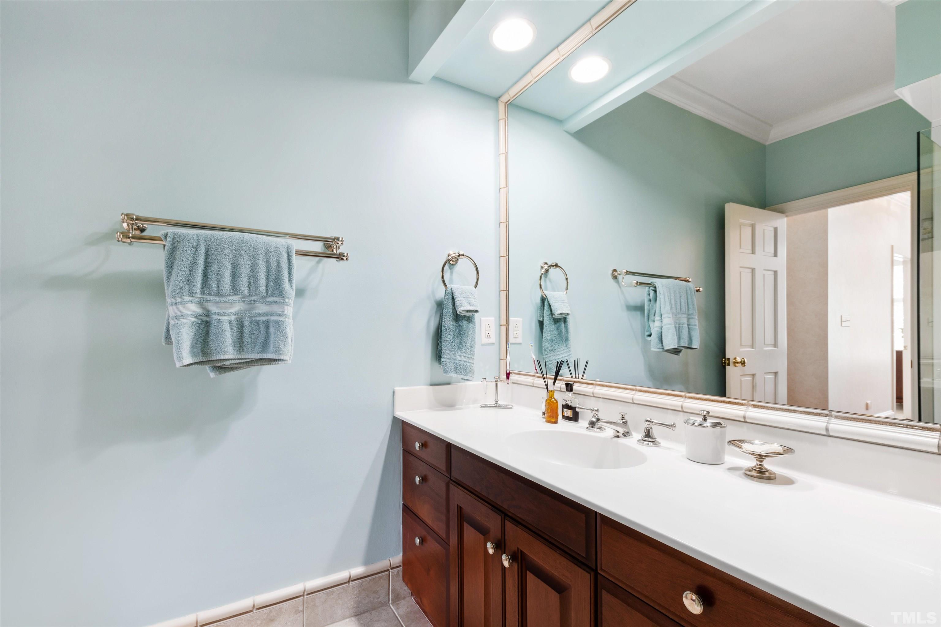 1909 Chase Court Raleigh, NC 27607 - Photo 70 of 87 a bathroom with a double vanity sink and a mirror