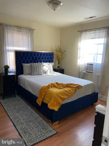 a bedroom with a large bed and a window