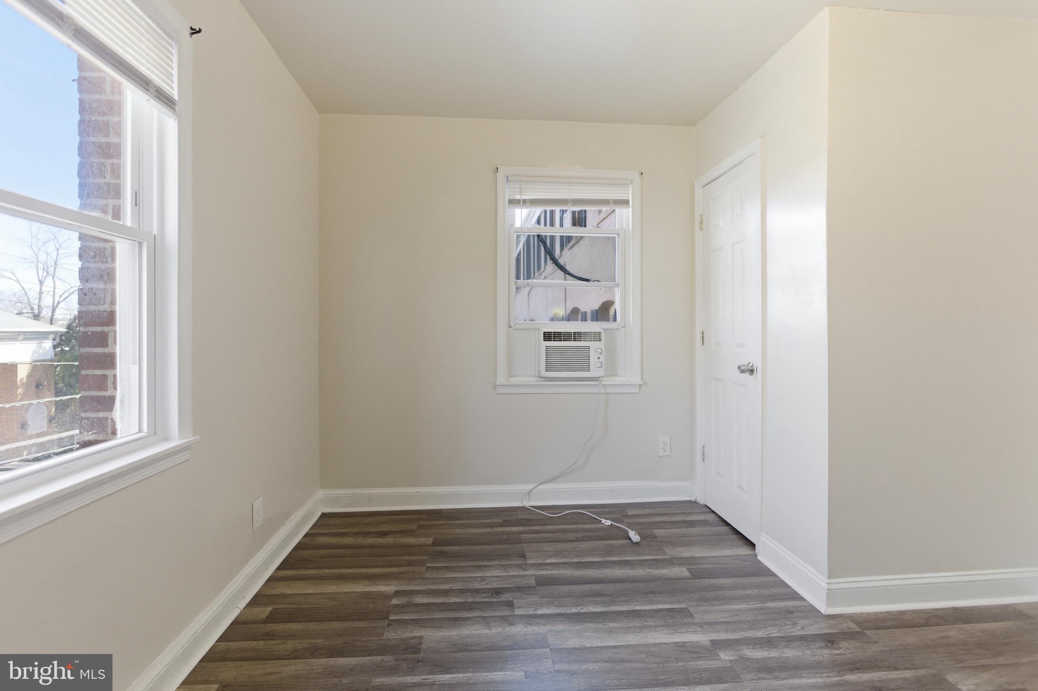 101 Wayne Place Southeast, Unit 2 Washington, DC 20032 - Photo 6 of 10 a view of an empty room with wooden floor and a window