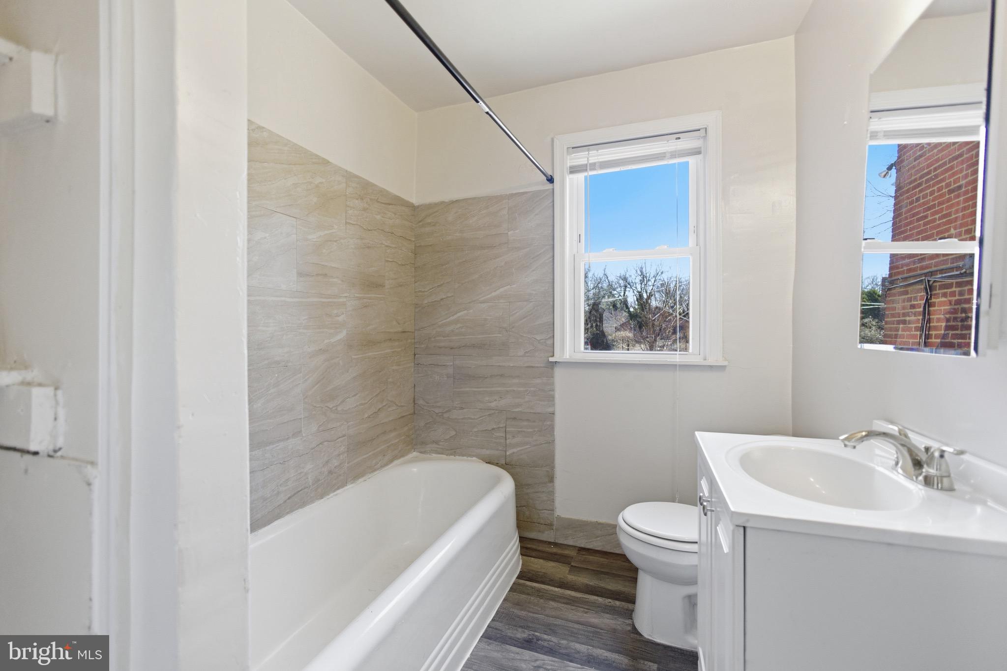 101 Wayne Place Southeast, Unit 2 Washington, DC 20032 - Photo 10 of 10 a bathroom with a sink toilet and bathtub
