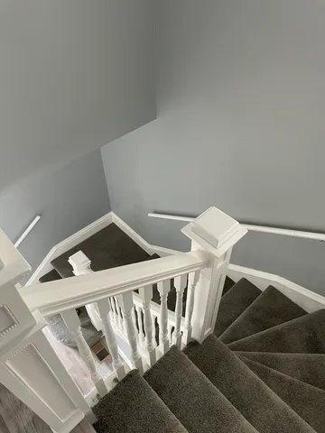 a view of staircase with white walls