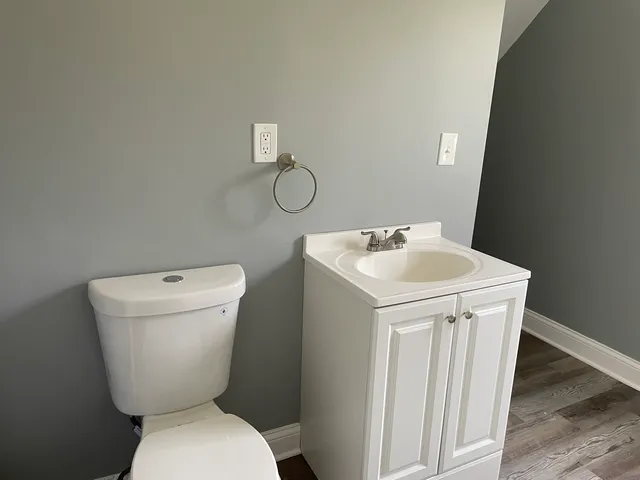 a white toilet sitting next to a white sink