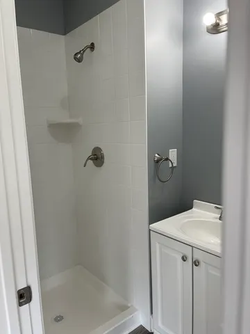 a bathroom with a shower toilet and sink