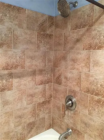 a bathroom with a toilet sink and shower