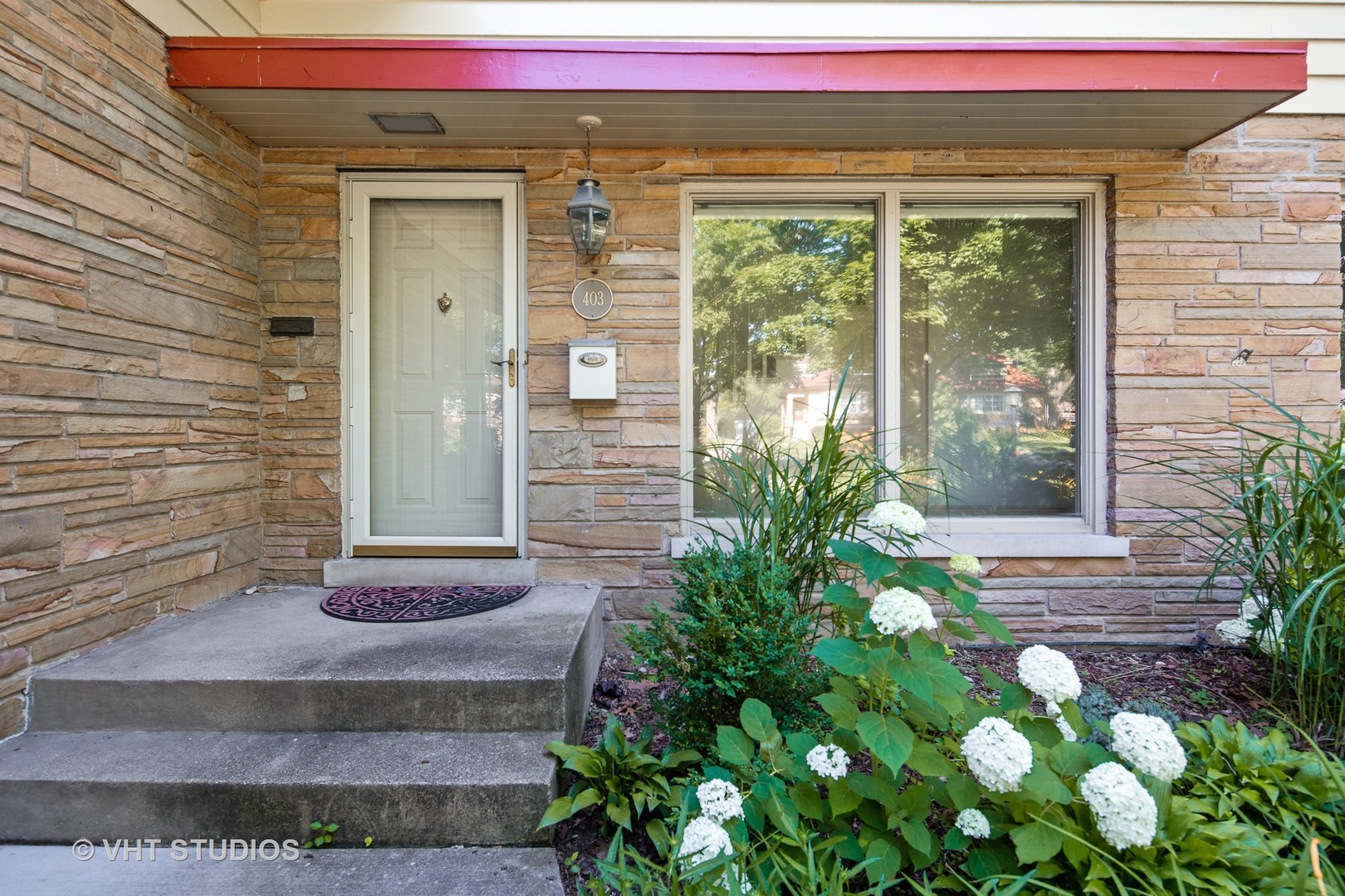 403 Uvedale Road Riverside, IL 60546 - Photo 22 of 26 a front view of a house with garden