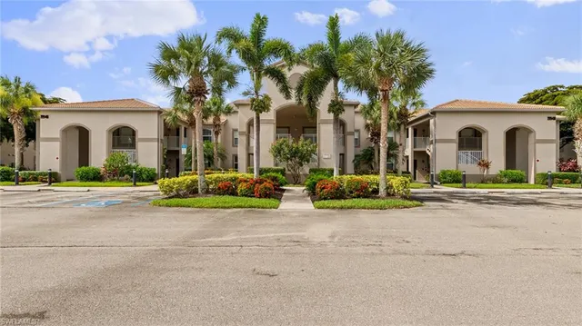 a front view of a house with a garden and a garage