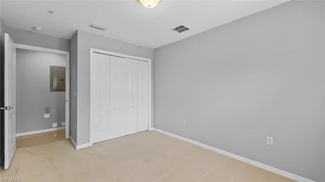 an empty room with closet area