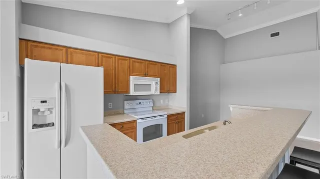 a kitchen with stainless steel appliances a refrigerator and a stove