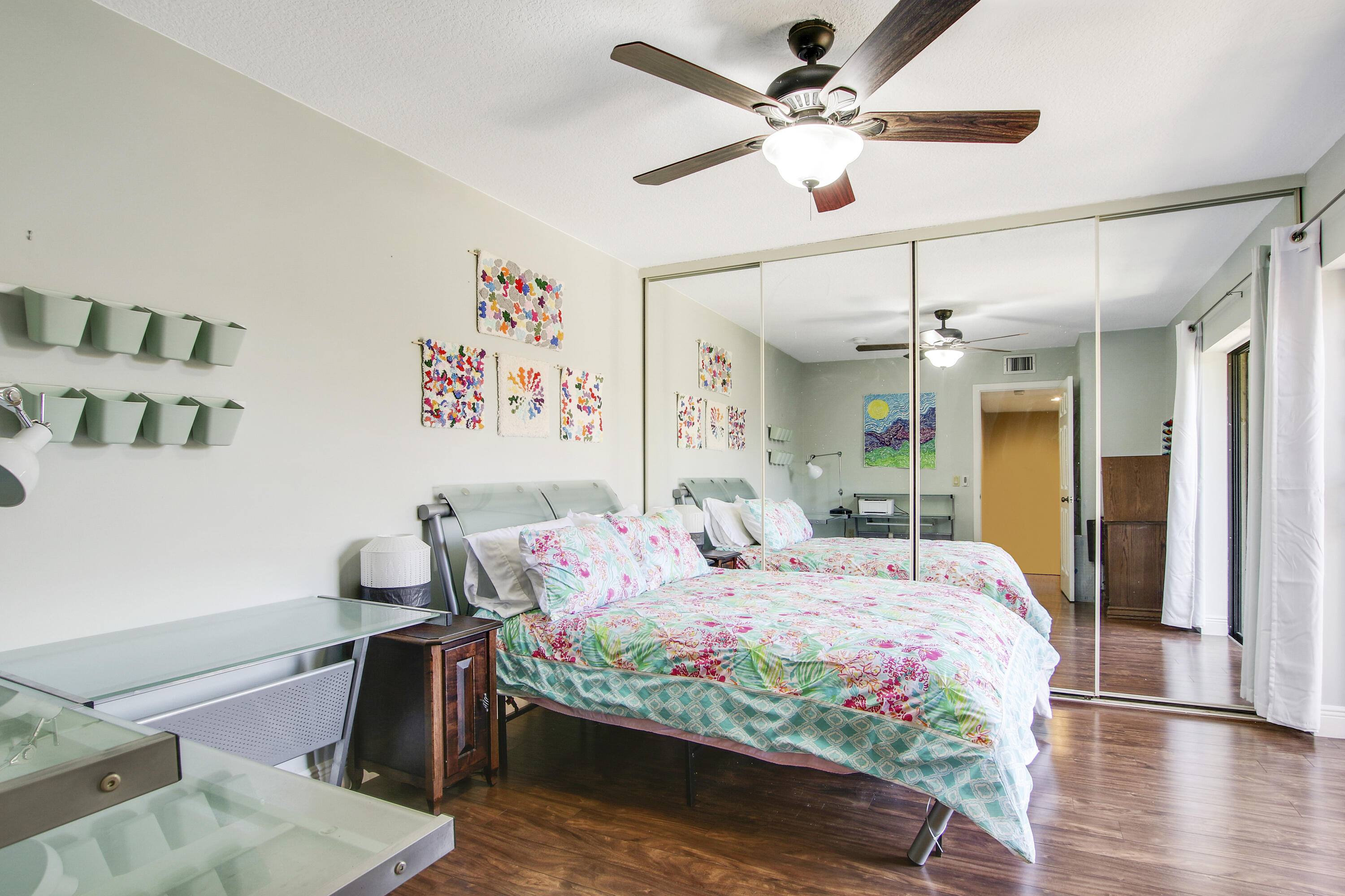 1205 12th Court Jupiter, FL 33477 - Photo 11 of 13 a bedroom with a bed and a chandelier