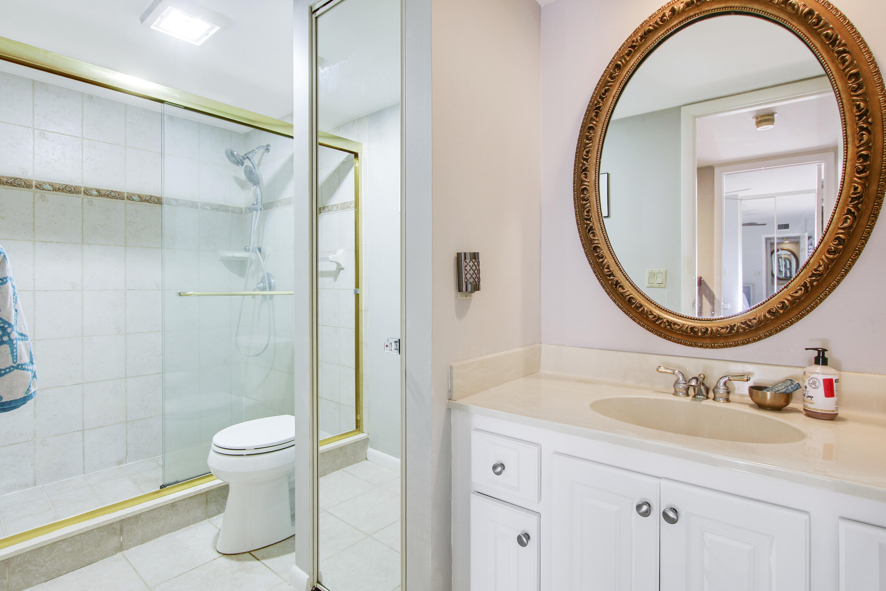1205 12th Court Jupiter, FL 33477 - Photo 12 of 13 a bathroom with a sink a toilet and a mirror