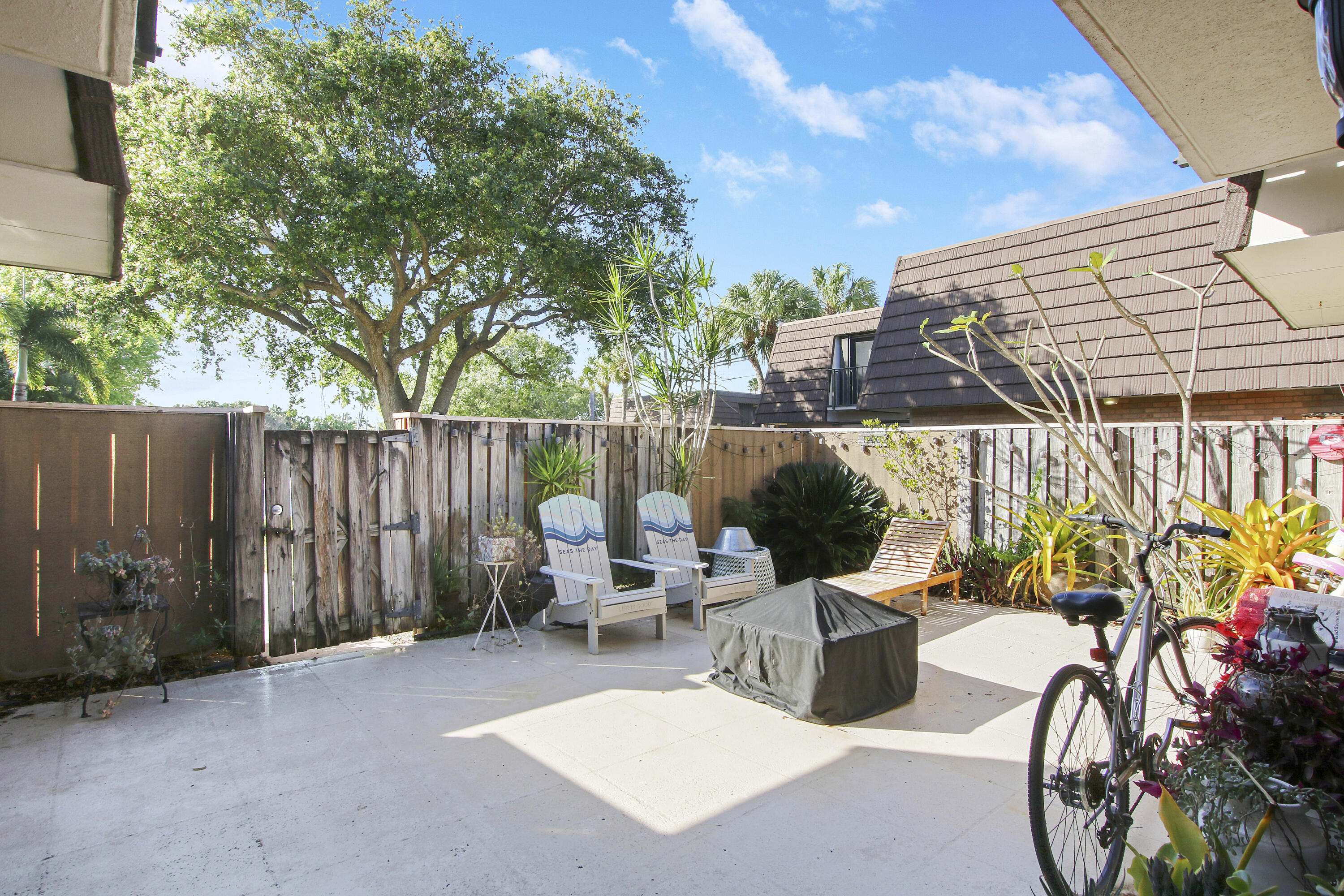 1205 12th Court Jupiter, FL 33477 - Photo 2 of 13 a view of backyard with outdoor seating and green space