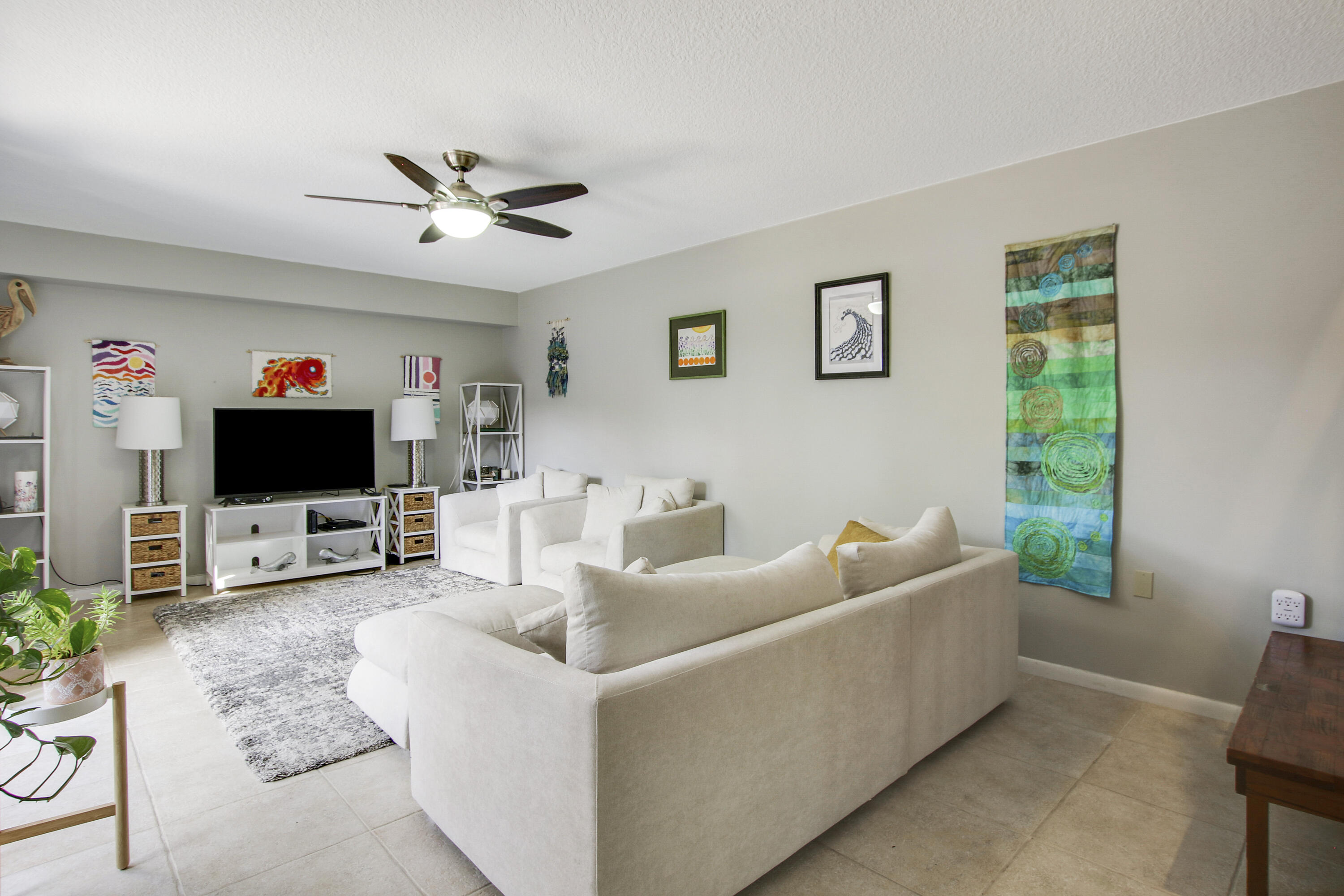 1205 12th Court Jupiter, FL 33477 - Photo 3 of 13 a living room with furniture and a flat screen tv