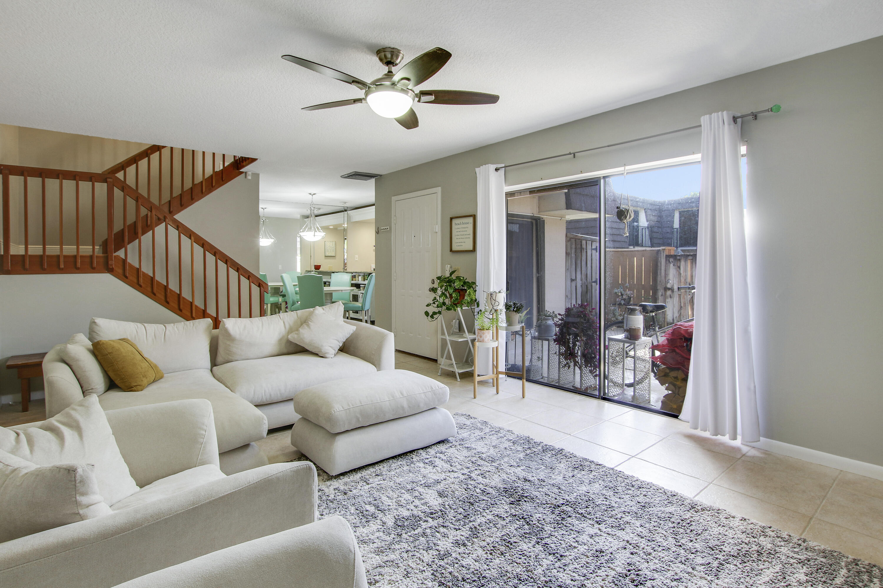 1205 12th Court Jupiter, FL 33477 - Photo 4 of 13 a living room with furniture ceiling fan and a rug