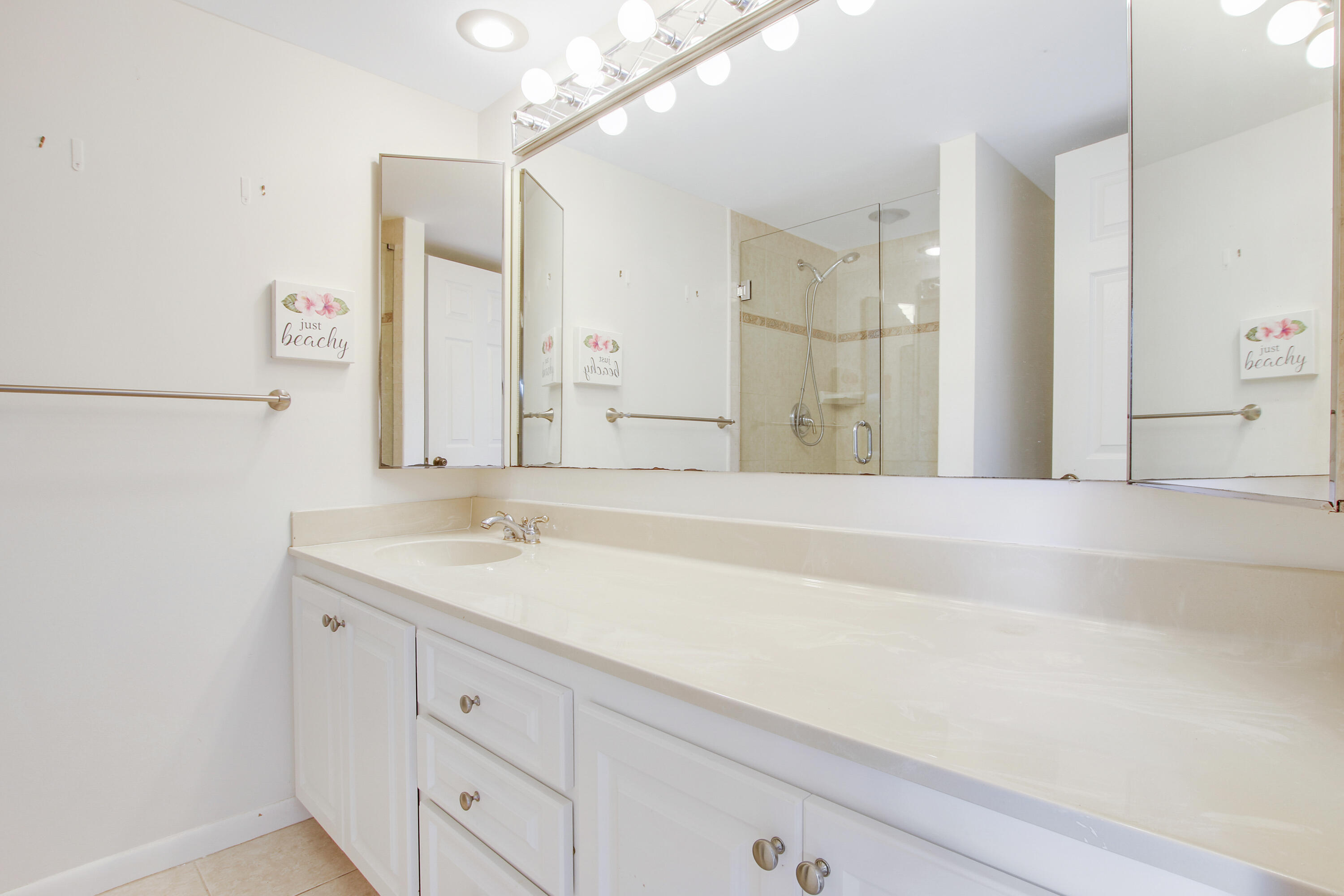 1205 12th Court Jupiter, FL 33477 - Photo 10 of 13 a bathroom with a sink and a mirror