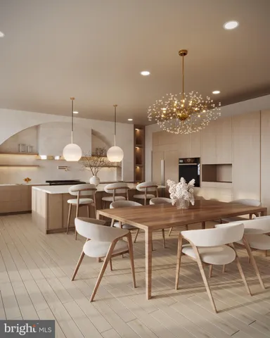 a view of a dining room and kitchen with furniture a chandelier and kitchen view
