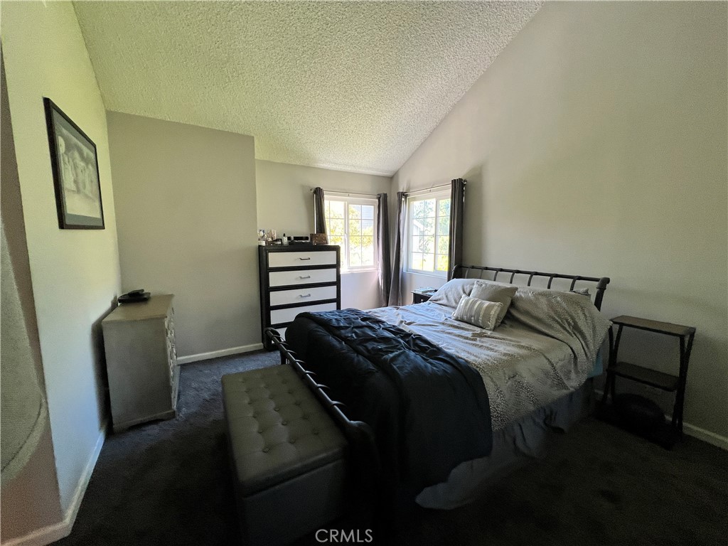 22031 Main, Unit 10 Carson, CA 90745 - Photo 5 of 10 a bedroom with a bed and wooden floor