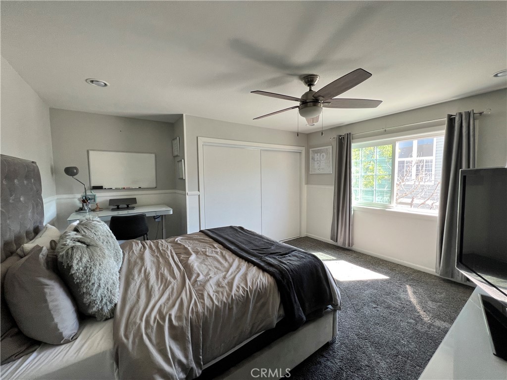 22031 Main, Unit 10 Carson, CA 90745 - Photo 7 of 10 a bedroom with a bed and a flat screen television