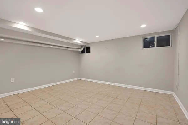 a view of a patio with a table and chairs and wooden fence