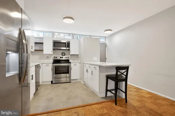a kitchen with stainless steel appliances granite countertop a sink and a stove