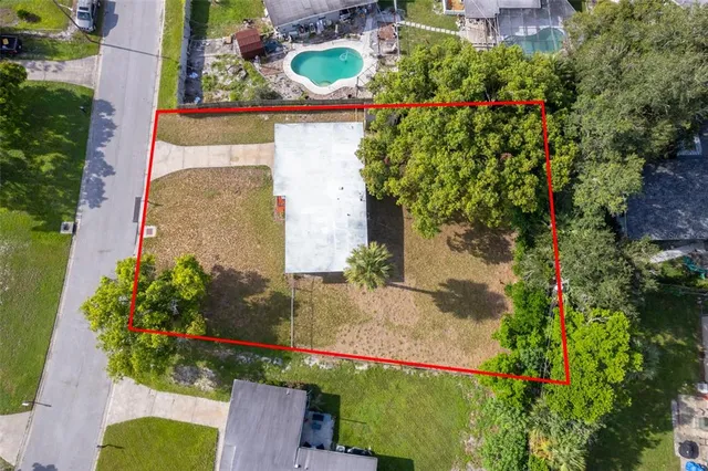 an aerial view of a house with a yard and garden