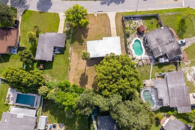 an aerial view of a house with a garden and yard