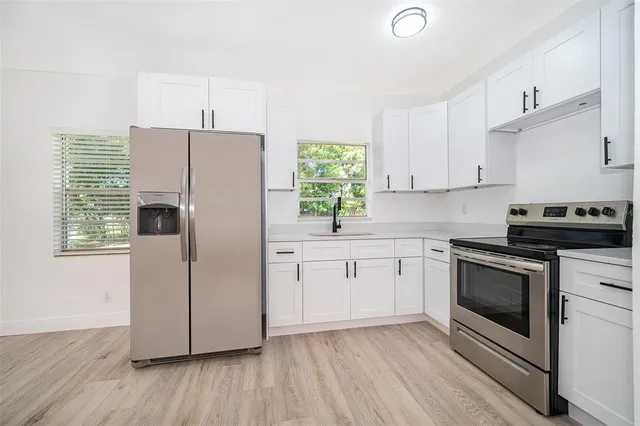 a kitchen with a white cabinets and white appliances