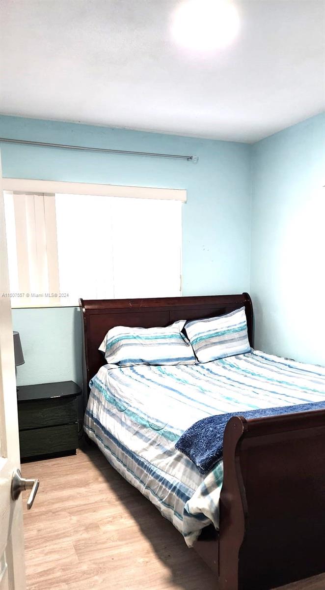 12441 Southwest 190th Terrace Miami, FL 33177 - Photo 12 of 24 a bedroom with a bed and window