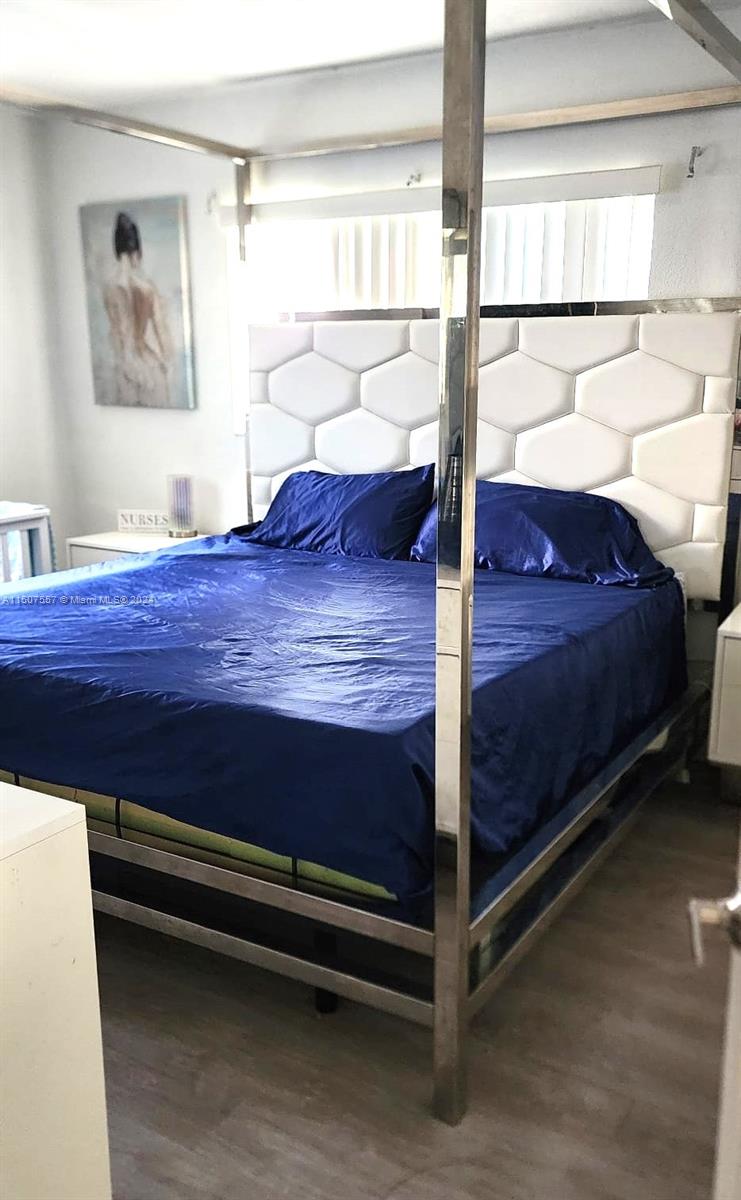 12441 Southwest 190th Terrace Miami, FL 33177 - Photo 13 of 24 a bed sitting in a bedroom next to a window