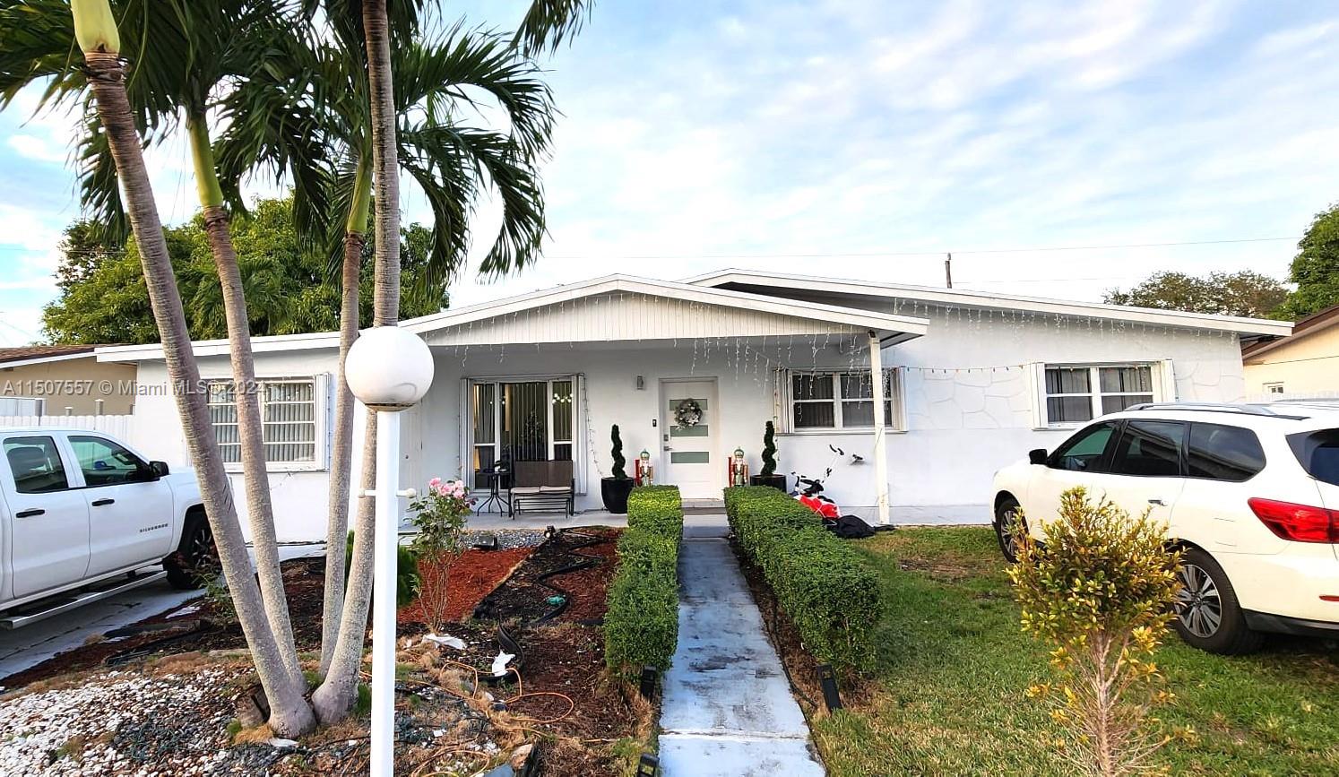 12441 Southwest 190th Terrace Miami, FL 33177 - Photo 2 of 24 a front view of a house with garden