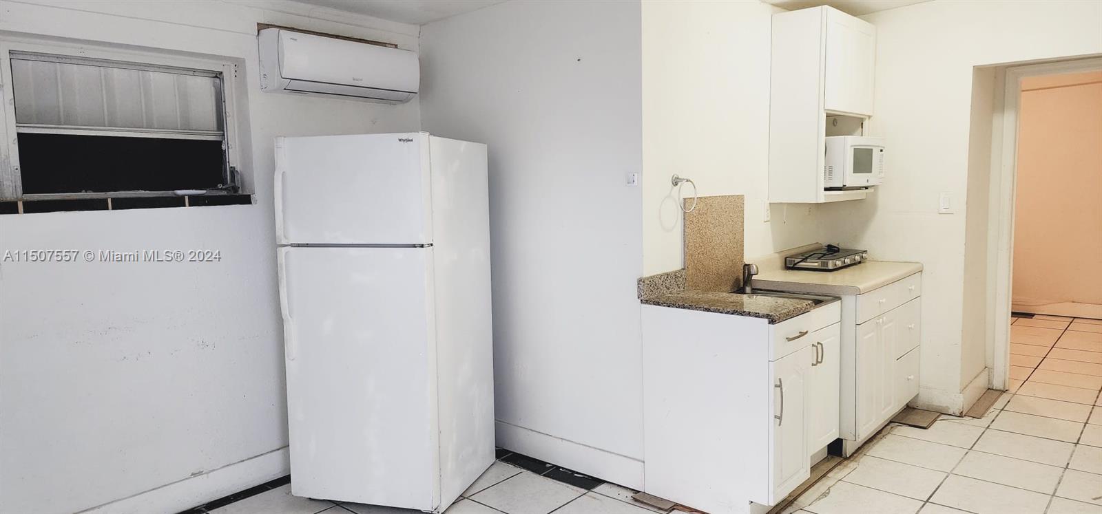 12441 Southwest 190th Terrace Miami, FL 33177 - Photo 21 of 24 a kitchen with a refrigerator and a stove