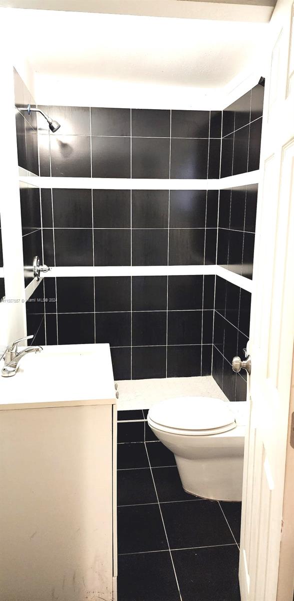 12441 Southwest 190th Terrace Miami, FL 33177 - Photo 22 of 24 a room with a black white wall and a black white checkered floor