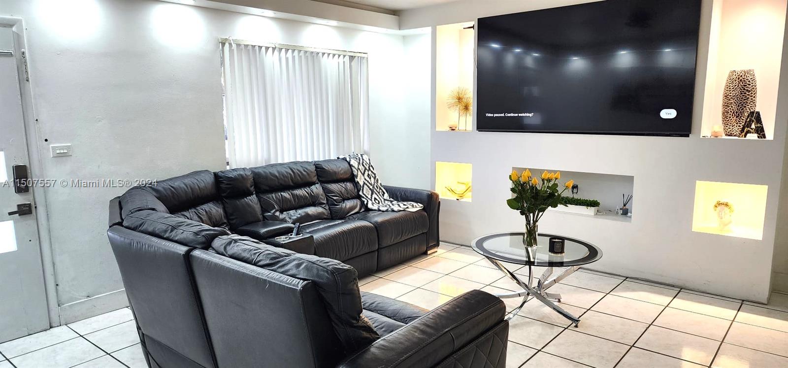 12441 Southwest 190th Terrace Miami, FL 33177 - Photo 6 of 24 a living room with furniture and a flat screen tv