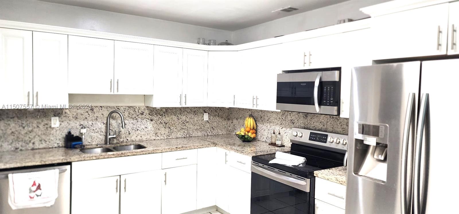 12441 Southwest 190th Terrace Miami, FL 33177 - Photo 9 of 24 a kitchen with stainless steel appliances granite countertop a sink and a stove