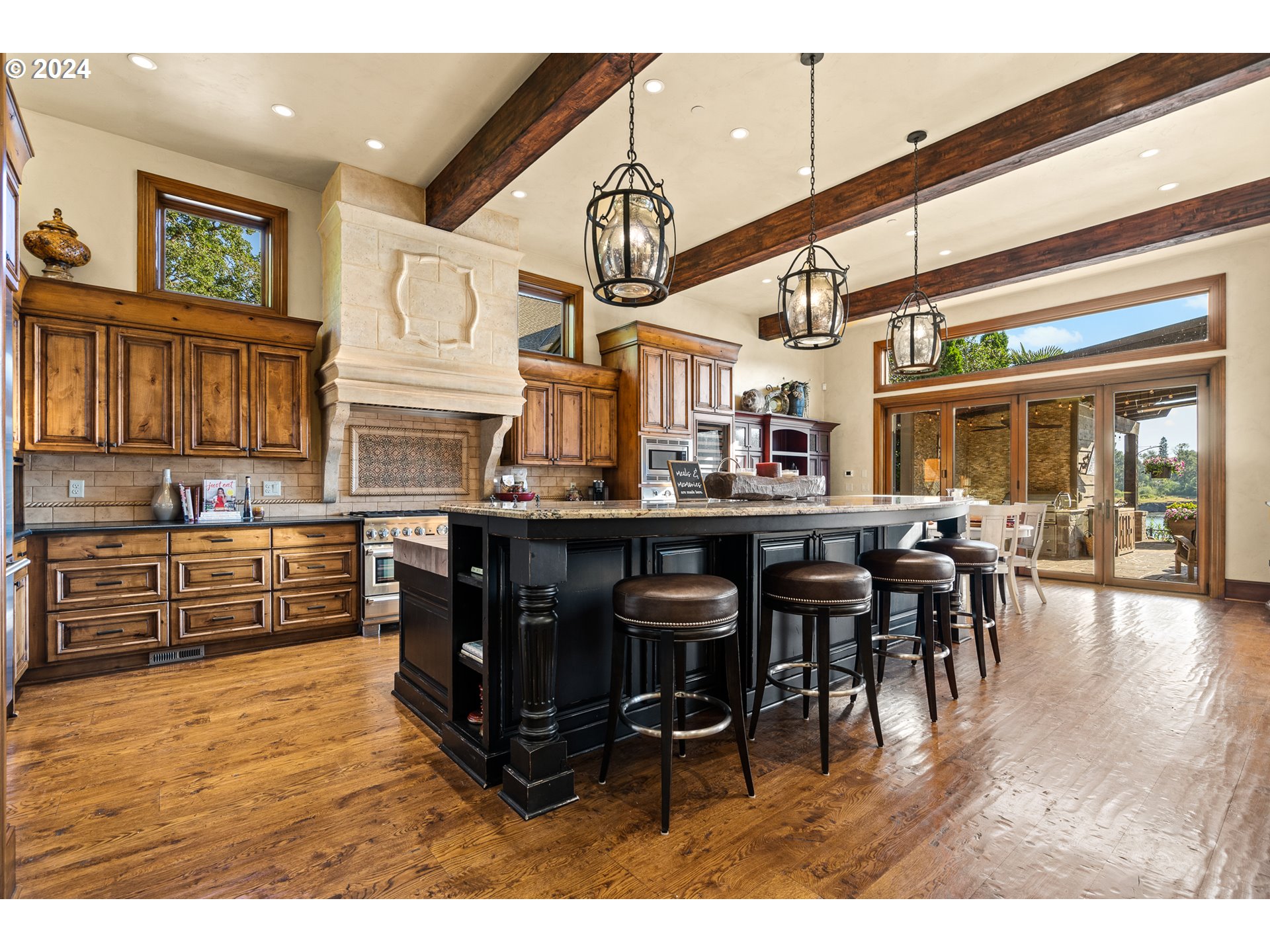 12780 South Fielding Road Lake Oswego, OR 97034 - Photo 13 of 48 a kitchen with stainless steel appliances kitchen island granite countertop a table chairs and a refrigerator