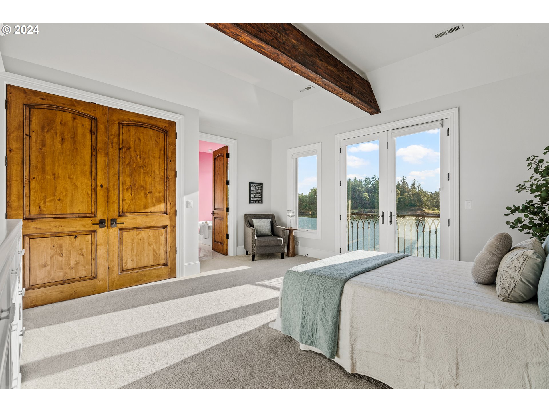 12780 South Fielding Road Lake Oswego, OR 97034 - Photo 31 of 48 a bedroom with a large bed and a large window