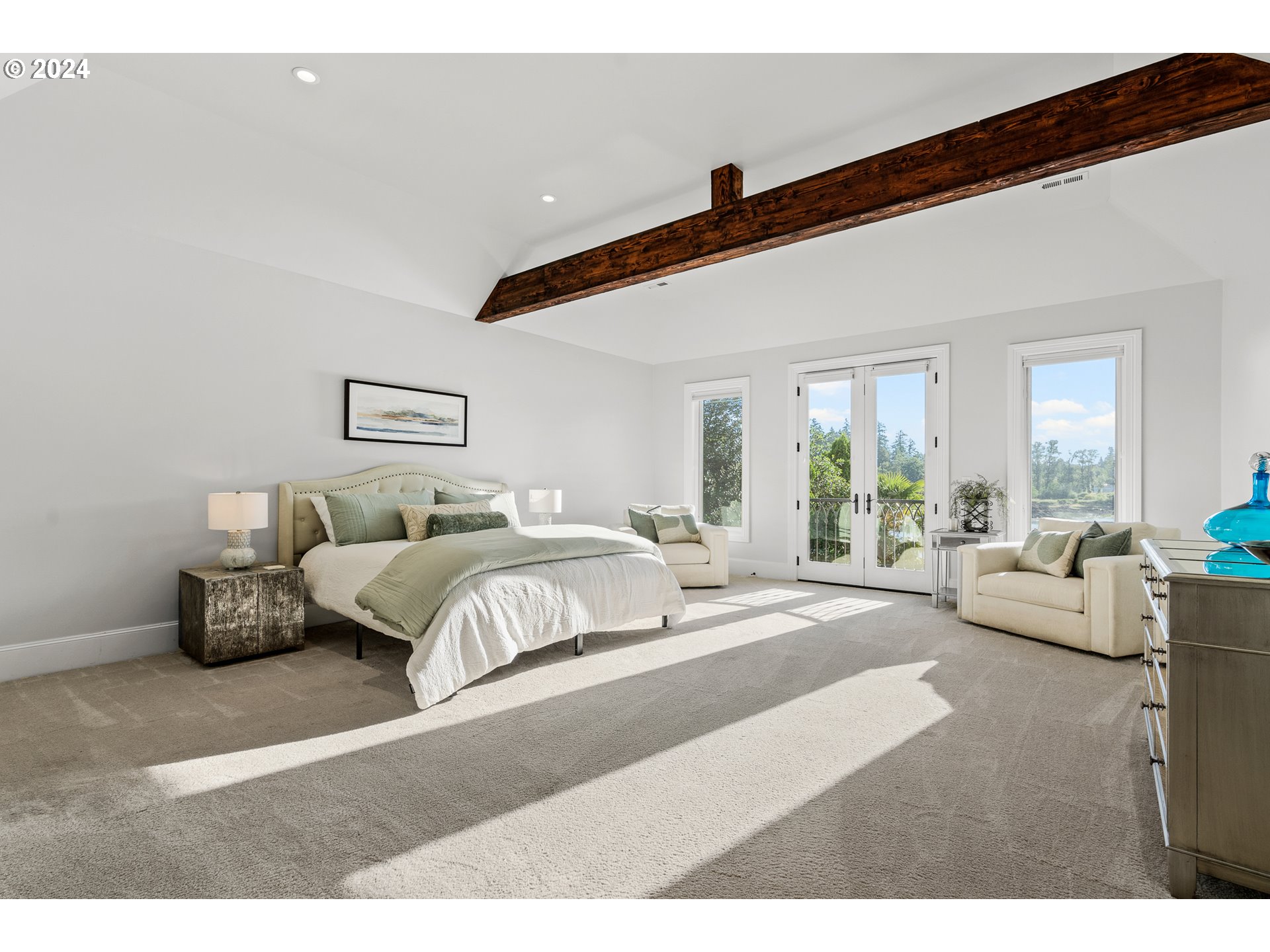 12780 South Fielding Road Lake Oswego, OR 97034 - Photo 35 of 48 a spacious bedroom with a bed a couch and large window
